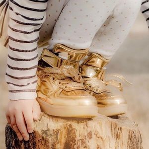 Metallic gold high top tennis shoes